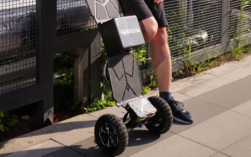 a person standing with electric mountain board telum 2wd