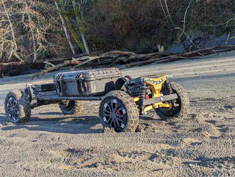 Riding Pro 2WD All Terrain Electric Skateboard on beach