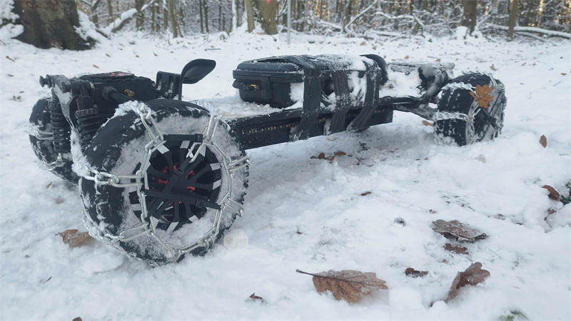 Riding Ecomobl M24Pro electric skateboard on snow-covered meadows with snow chains at minus 5°C/23°F