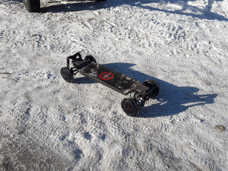 an electric skateboard on the snow