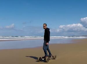 riding an electric skateboard on the beach