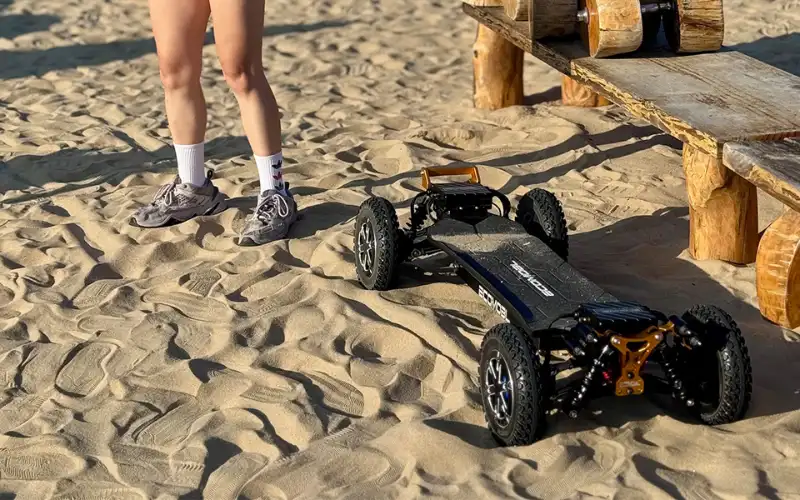 m24 pro 4wd e-skateboard on the beach