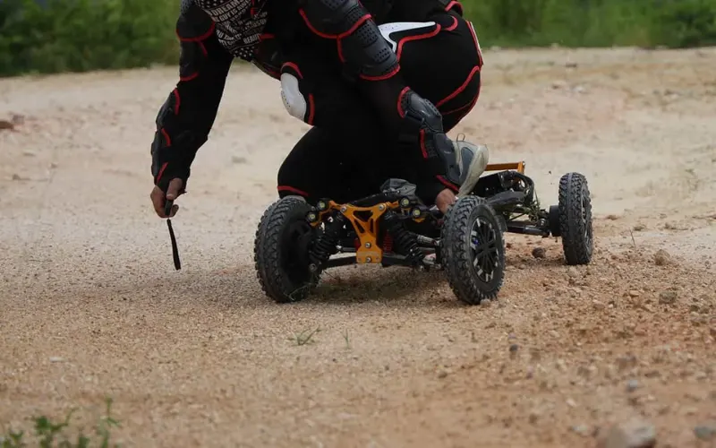 man riding m24 pro 4wd electric skateboard by holding it