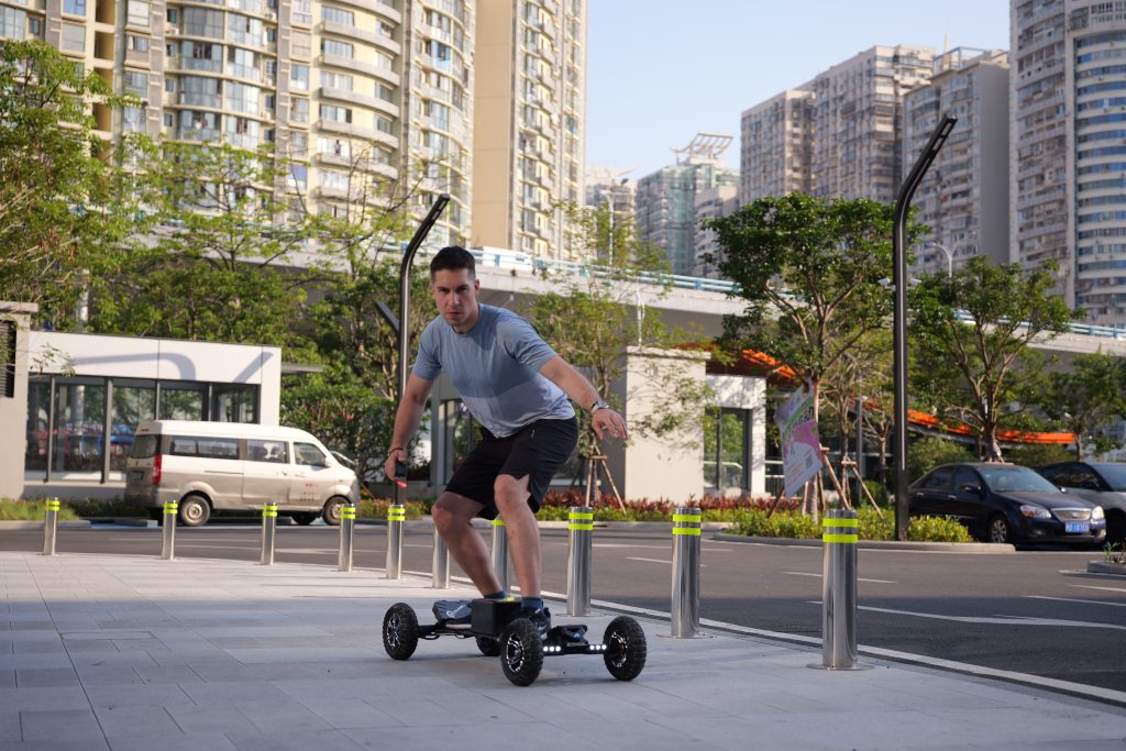 man riding an electric skateboard on the road