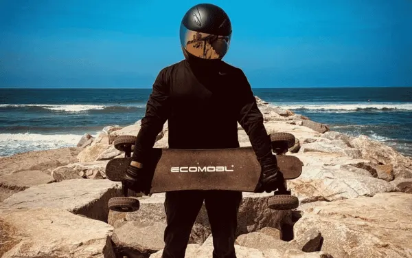 man holding an electric skateboard