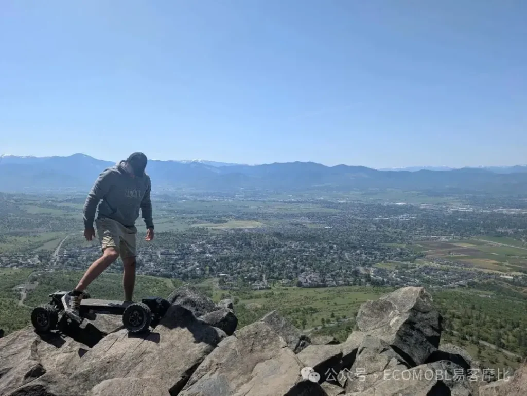 man standing on an electric skateboard on the mountain