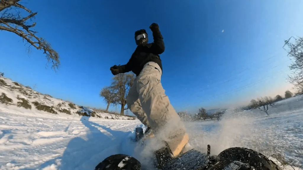 riding an electric skateboard on the snow